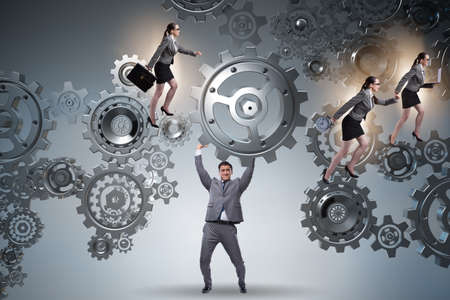 Businessman supporting gear in teamwork conceptの写真素材