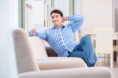 Young man shopping in furniture storeの写真素材