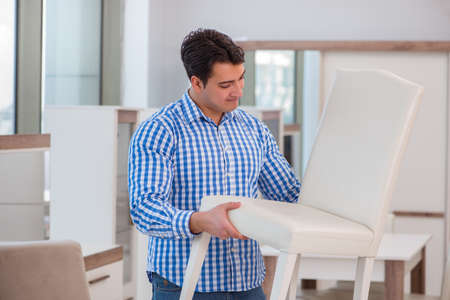Young man shopping in furniture storeの写真素材