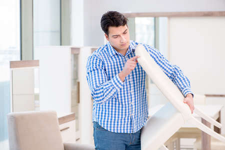 Young man shopping in furniture storeの写真素材