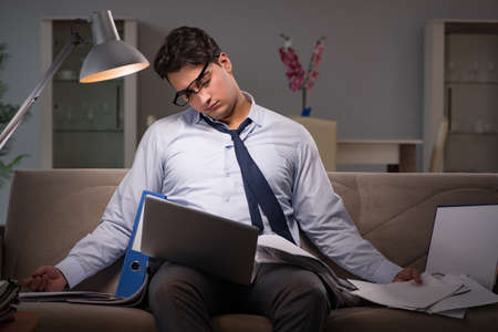 Businessman workaholic working late at home