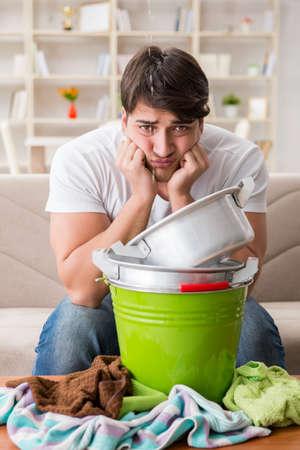 Man at home dealing with neighbor flood leakの写真素材
