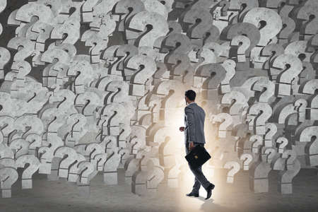 Businessman facing questions in businessの写真素材