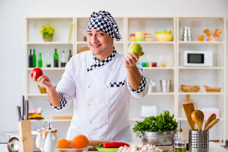 Young male cook working in the kitchenの写真素材