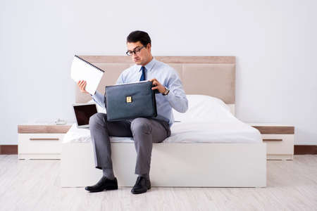Businessman working in hotel roomの写真素材