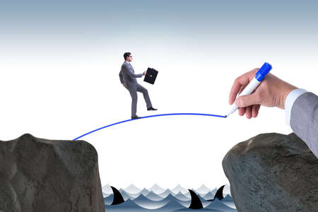 Hand drawing bridge under businessmanの写真素材