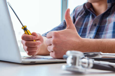 Computer repairman repairing computer laptopの写真素材