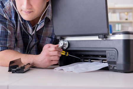 Repairman repairing broken color printer