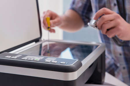 Repairman repairing broken color printer