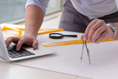 Male engineer working on drawings and blueprints