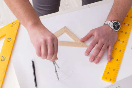 Male engineer working on drawings and blueprints