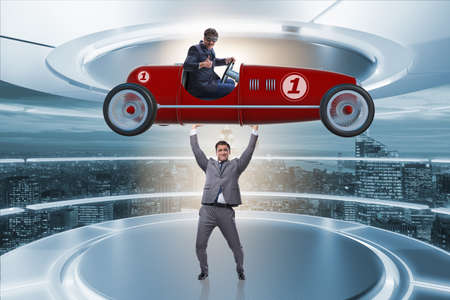 Businessman lifting sports car in power conceptの写真素材