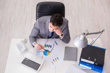 View from top on businessman working on business chartsの写真素材