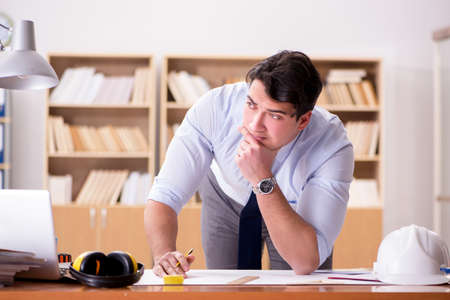 Engineer supervisor working on drawings in the office