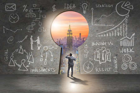 Businessman standing in front of keyholeの写真素材