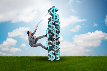 Businessman climbing dollar challenge towerの写真素材