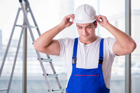 Young worker with safety helmet hardhatの写真素材