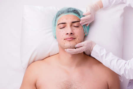 Handsome man in spa massage conceptの写真素材