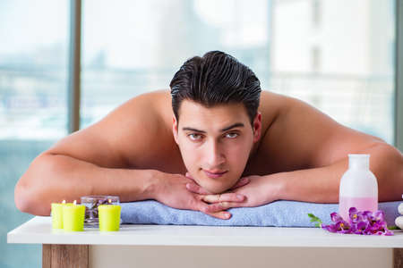 Handsome man in spa massage conceptの写真素材