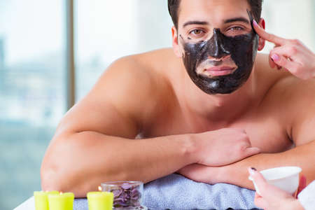 Handsome man in spa massage conceptの写真素材