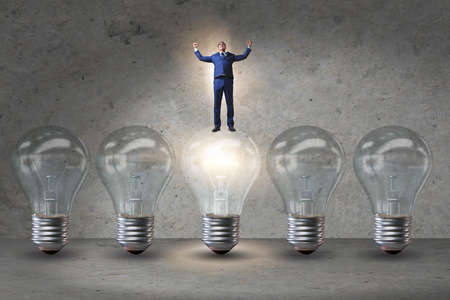 Businessman in new idea concept with light bulbの写真素材
