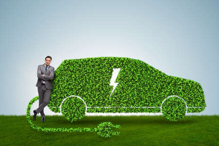 Businessman in green electric car conceptの写真素材