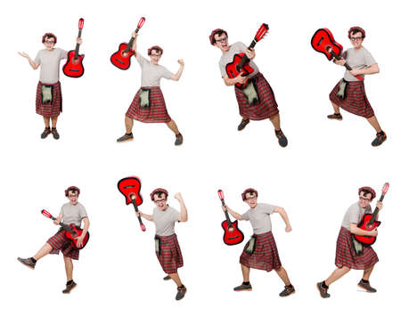 Scotsman playing guitar isolated on whiteの写真素材