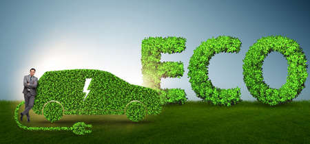 Businessman in green electric car conceptの写真素材