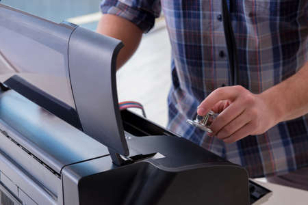 Repairman repairing broken color printer