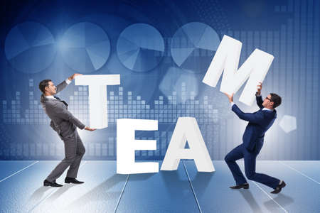 Teamwork concept with businessman putting lettersの写真素材