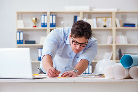 Male engineer working on drawings and blueprints