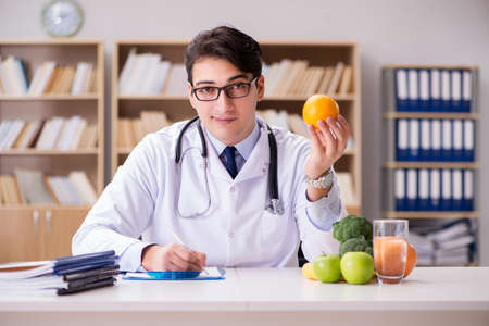 Doctor in dieting concept with fruits and vegetablesの写真素材