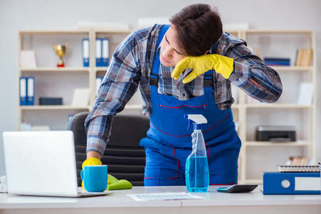 Male cleaner working in the office