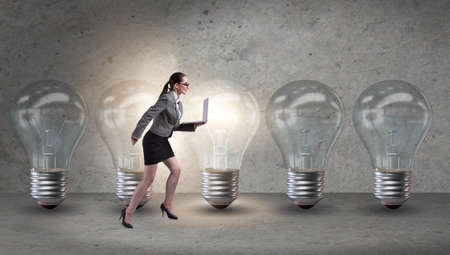Businesswoman in new idea concept with light bulbの写真素材