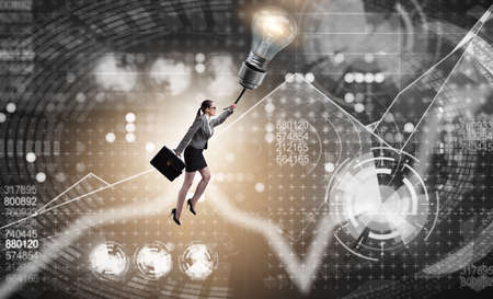 Businessman flying on lamp balloonの写真素材