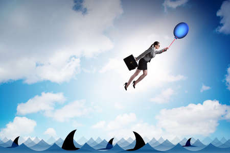Businesswoman flying holding balloonの写真素材