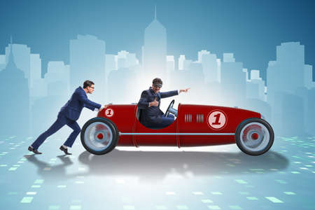 Businessman car pushing in teamwork conceptの写真素材