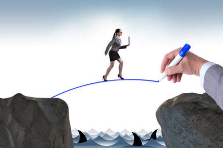 Hand drawing bridge under businesswomanの写真素材