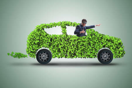 Businessman in green electric car conceptの写真素材