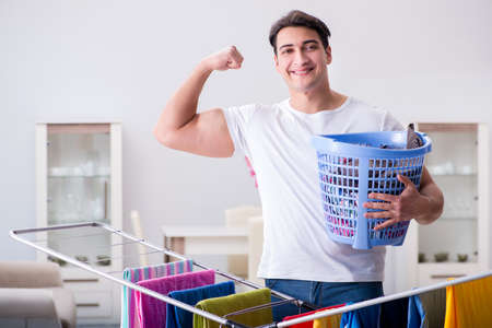 Man doing laundry at homeの写真素材