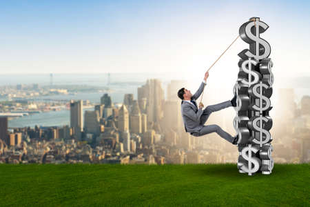Businessman climbing dollar challenge towerの写真素材