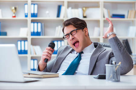 Businessman singing in the officeの写真素材