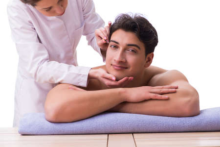 Handsome man in spa massage conceptの写真素材