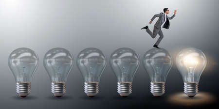 Businessman in new idea concept with light bulbの写真素材