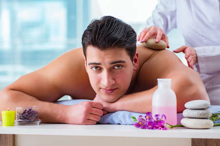 Handsome man in spa massage conceptの写真素材