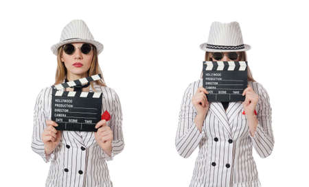 Beautiful girl in striped clothing holding clapperboard isolatedの写真素材