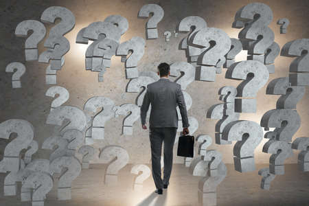 Businessman facing questions in businessの写真素材