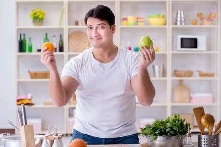 Young male cook working in the kitchenの写真素材