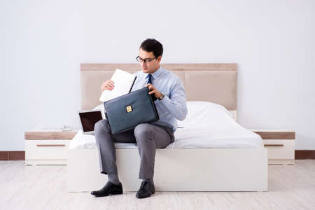 Businessman working in hotel roomの写真素材