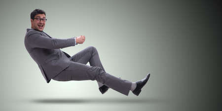 Businessman driving virtual car in funny conceptの写真素材